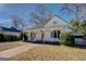Charming white cottage with a front porch and well-maintained lawn at 2173 Anderson Se Ave, Covington, GA 30014