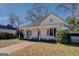 White house with a porch, brick walkway, and American flag at 2173 Anderson Se Ave, Covington, GA 30014