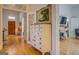 Bright hallway with hardwood floors and antique dresser at 2173 Anderson Se Ave, Covington, GA 30014