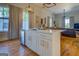 White kitchen island with seating and view into the living and dining areas at 2173 Anderson Se Ave, Covington, GA 30014