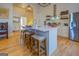 Modern kitchen with white cabinets, island with seating, and stainless steel appliances at 2173 Anderson Se Ave, Covington, GA 30014