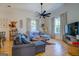 Bright living room with hardwood floors, comfortable sectional sofa, and large TV at 2173 Anderson Se Ave, Covington, GA 30014