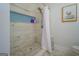 Shower with marble tile surround and a built-in shelf at 2173 Anderson Se Ave, Covington, GA 30014