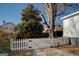 White picket fence encloses a side yard with gravel driveway at 2173 Anderson Se Ave, Covington, GA 30014