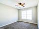 Bright bedroom featuring carpet, ceiling fan, and large window at 221 Stagecoach Pass, Temple, GA 30179