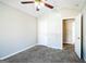 Bedroom with carpet flooring, ceiling fan and access to a hallway at 221 Stagecoach Pass, Temple, GA 30179