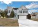 Two-story house with a two-car garage and manicured lawn at 221 Stagecoach Pass, Temple, GA 30179