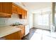 Bright kitchen features wood cabinets, and a view to the dining area at 221 Stagecoach Pass, Temple, GA 30179