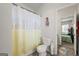 Small bathroom with a toilet and shower, plus a view of a bedroom at 120 Emerson Trl, Covington, GA 30016