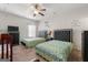 Bedroom with two twin beds, a ceiling fan, and decorative wall art at 120 Emerson Trl, Covington, GA 30016