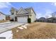 Rear view of a two-story house with a large backyard at 120 Emerson Trl, Covington, GA 30016