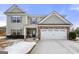 Two-story house with stone accents and a three-car garage at 120 Emerson Trl, Covington, GA 30016