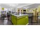 Island kitchen with lime green cabinets, open to living room at 120 Emerson Trl, Covington, GA 30016