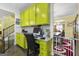 Bright kitchen features lime green cabinets, granite countertops, and a built-in workspace at 120 Emerson Trl, Covington, GA 30016