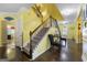 Grand staircase with dark wood floors and metal railing at 120 Emerson Trl, Covington, GA 30016