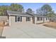 Tan house with black shutters and a long driveway at 234 Willis Rd, Sharpsburg, GA 30277