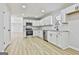 Modern kitchen with white cabinets, granite countertops, and stainless steel appliances at 234 Willis Rd, Sharpsburg, GA 30277