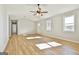 Bright living room with wood-look floors, neutral walls, and natural light from two windows at 234 Willis Rd, Sharpsburg, GA 30277
