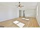 Spacious living room featuring wood-look flooring and a ceiling fan with light fixture at 234 Willis Rd, Sharpsburg, GA 30277