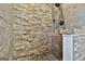 Walk-in shower with stone tile and pebble floor at 234 Willis Rd, Sharpsburg, GA 30277