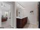 Bright bathroom with a dark wood vanity, white countertops and tile flooring at 244 Sturry Dr, Mcdonough, GA 30252