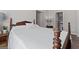 Bright and airy bedroom with a traditional poster bed and an adjacent bathroom at 244 Sturry Dr, Mcdonough, GA 30252