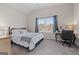 Bedroom featuring a ceiling fan, carpet, a large window, and simple decor at 244 Sturry Dr, Mcdonough, GA 30252