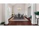 Elegant dining room featuring stylish chandelier lighting, beautiful dark hardwood flooring, and a decorative area rug at 244 Sturry Dr, Mcdonough, GA 30252
