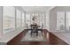 Bright dining area featuring large windows, stylish lighting, and hardwood floors with decorative area rug at 244 Sturry Dr, Mcdonough, GA 30252