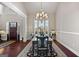 Traditional dining room with a decorative rug, large window with blinds, and a decorative chandelier at 244 Sturry Dr, Mcdonough, GA 30252