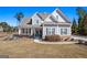 Charming gray home featuring beautiful landscaping, a welcoming porch, and classic architectural details at 244 Sturry Dr, Mcdonough, GA 30252