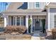 Charming front porch with columns, landscaping, and a dark-stained front door at 244 Sturry Dr, Mcdonough, GA 30252
