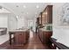 Well-lit kitchen features granite counters, dark wood cabinets, and a kitchen island with bar stool seating at 244 Sturry Dr, Mcdonough, GA 30252