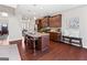 Well-lit kitchen features granite counters, dark wood cabinets, and a kitchen island with bar stool seating at 244 Sturry Dr, Mcdonough, GA 30252