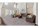 Spacious living room featuring a brick fireplace, large windows, vaulted ceilings, and comfortable seating at 244 Sturry Dr, Mcdonough, GA 30252