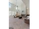 Open living room featuring a fireplace, two-story ceilings, and bright windows at 244 Sturry Dr, Mcdonough, GA 30252