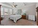 Cozy bedroom boasts tray ceilings, soft lighting, and a plush bed with decorative pillows at 244 Sturry Dr, Mcdonough, GA 30252
