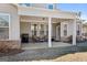 Covered outdoor patio featuring seating area, ceiling fan, and brick accents at 244 Sturry Dr, Mcdonough, GA 30252