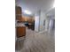 Simple kitchen with wood cabinets, stainless steel appliances, and wood-look floors at 2351 Perry Nw Blvd, Atlanta, GA 30318