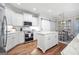 Modern kitchen with white cabinets, large island, and stainless steel appliances at 37 Waterstone Se Dr, Cartersville, GA 30121