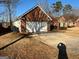 Brick home with attached two-car garage and driveway at 439 Camella Cir, Mcdonough, GA 30252