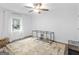 Bedroom with hardwood floors, ceiling fan, and pet enclosure at 1200 Mount Carmel Rd, Mcdonough, GA 30253