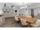 Open concept dining room with a wooden table, hardwood floors, and views into the living room and kitchen at 1200 Mount Carmel Rd, Mcdonough, GA 30253
