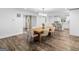 Bright dining room features a large wooden table with seating for six and views into the kitchen at 1200 Mount Carmel Rd, Mcdonough, GA 30253