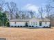 Newly renovated ranch home with a large backyard and modern exterior at 1200 Mount Carmel Rd, Mcdonough, GA 30253