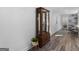 Bright hallway with hardwood floors and a wooden display cabinet at 1200 Mount Carmel Rd, Mcdonough, GA 30253