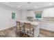 Modern kitchen with white cabinets, stainless steel appliances and a large island with seating for two at 1200 Mount Carmel Rd, Mcdonough, GA 30253