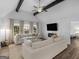 Open living space with hardwood floors, large windows, and vaulted ceiling at 1200 Mount Carmel Rd, Mcdonough, GA 30253