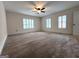 Bright bedroom featuring a ceiling fan and plantation shutters at 7963 Smith Rd, Villa Rica, GA 30180