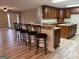 Kitchen features a breakfast bar with four stools and ample cabinetry at 7963 Smith Rd, Villa Rica, GA 30180